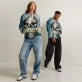 Two people wearing the all over print eye of Horus pyramid hoodies with a symbol design on a plain background