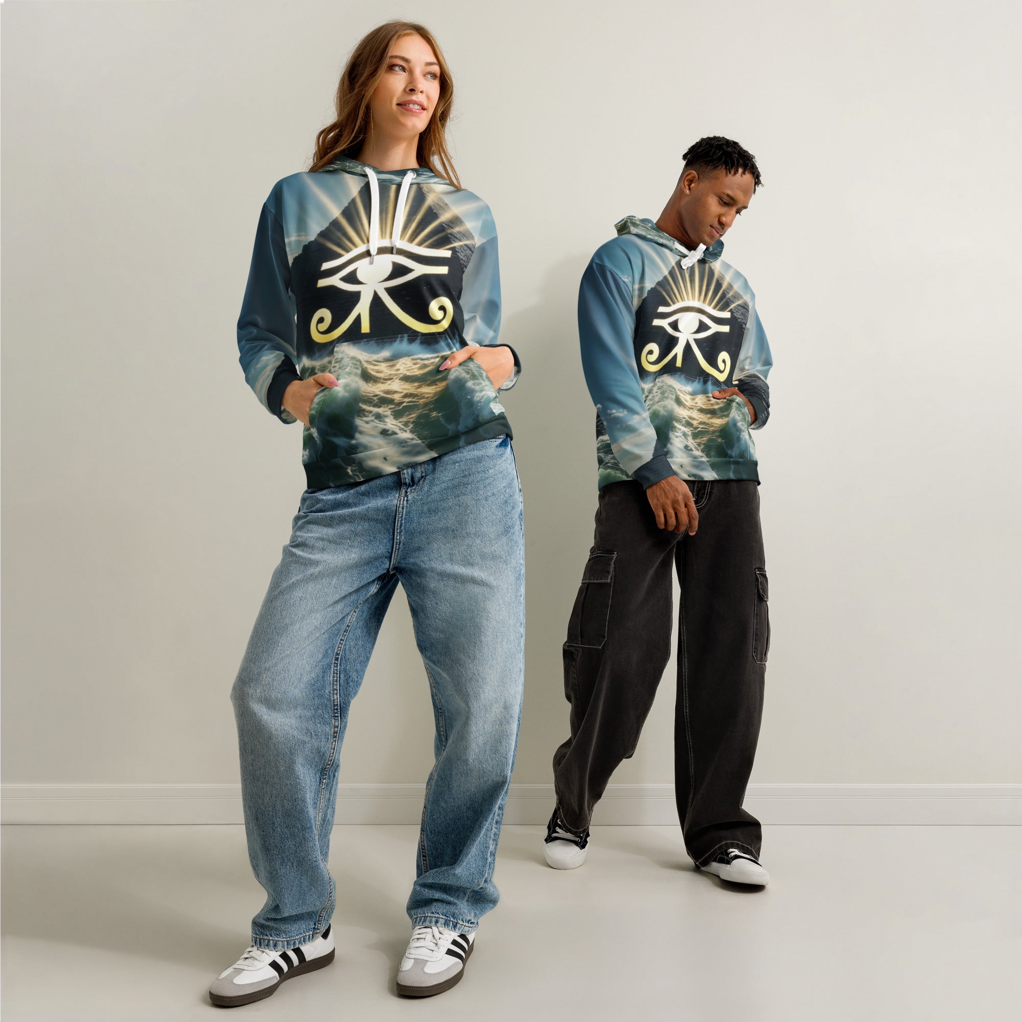 Two people wearing the all over print eye of Horus pyramid hoodies with a symbol design on a plain background