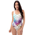 Woman with long dark hair wearing Cymatics Heart Sacred Geometry One-Piece Swimsuit with colorful glowing heart mandala pattern, front view