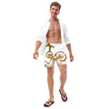 Man wearing Golden Cymatics Sacred Geometry Recycled Swim Trunks in white and gold pattern on beach