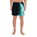 Man wearing Moon Symbol Athletic Long Shorts with glowing teal moon design on black background, front view