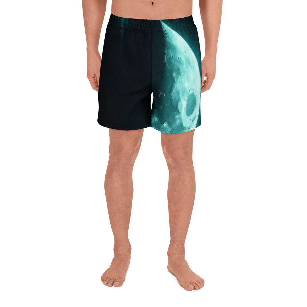 Man wearing Moon Symbol Athletic Long Shorts with glowing teal moon design on black background, front view